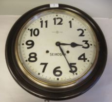 An early 20thC Seikosha mahogany cased dial clock; the gong strike movement faced by Arabic numerals