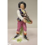A 19thC Derby porcelain standing figure, a fishmonger wearing striped breeches and boots  7.5"h