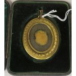 A 19thC gilt metal, glazed oval portrait miniature frame with laurel wreath and bead bordered