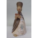 A Margit Kovacs art pottery figure wearing a hat and holding a heart  7"h