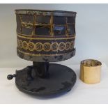 An early Victorian table top zoetrope, a pre-film, manually operated animation device, on a circular
