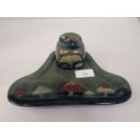 A Moorcroft pottery Claremont pattern inkstand, the reservoir with a cover, on a tray base,