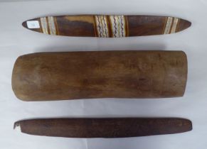 Aboriginal wooden artefacts, viz. a carved and painted parrying shield  20"h; a carved flat