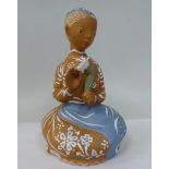 A Margit Kovacs art pottery figure, a woman kneeling, holding a flower  8.5"h