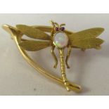 A 15ct gold brooch, fashioned as a wishbone and a dragonfly with an opal set body