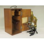 A German E Leitz Wetzlar black enamelled and lacquered brass microscope, no.84914 with three