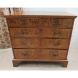 An 18thC and later walnut veneered dressing chest, having a quartered and crossbanded top, over two
