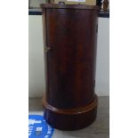 A Victorian mahogany cylindrical pot cupboard with an inset maroon hide surface and full height