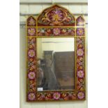 A modern mirror, the plate set in a laminated Asian inspired wooden frame, decorated in bright