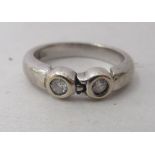 An 18ct white gold, two diamond set ring