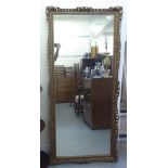 A modern mirror, in an ornate pierced gilt frame  60" x 27"