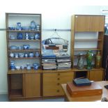 A 1970s/80s G-Plan teak living room unit with open shelves, over four drawers and four sliding doo