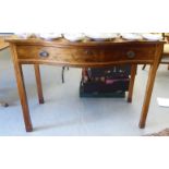 An early 20thC mahogany serpentine front, single drawer side/serving table, raised on square legs