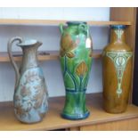 Three pieces of early 20thC pottery: to include a Lauder Barum jug with foliage ornament