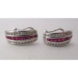 A pair of 14k white gold, ruby and diamond set earrings