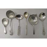 Silver collectables: to include a sifter spoon; a tea strainer; and a caddy spoon  mixed marks