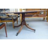 A Regency mahogany tip-top pedestal table, raised on a splayed quadruped base and brass casters