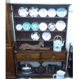 A George III oak dresser, the superstructure having a three tier plate rack, over two inline