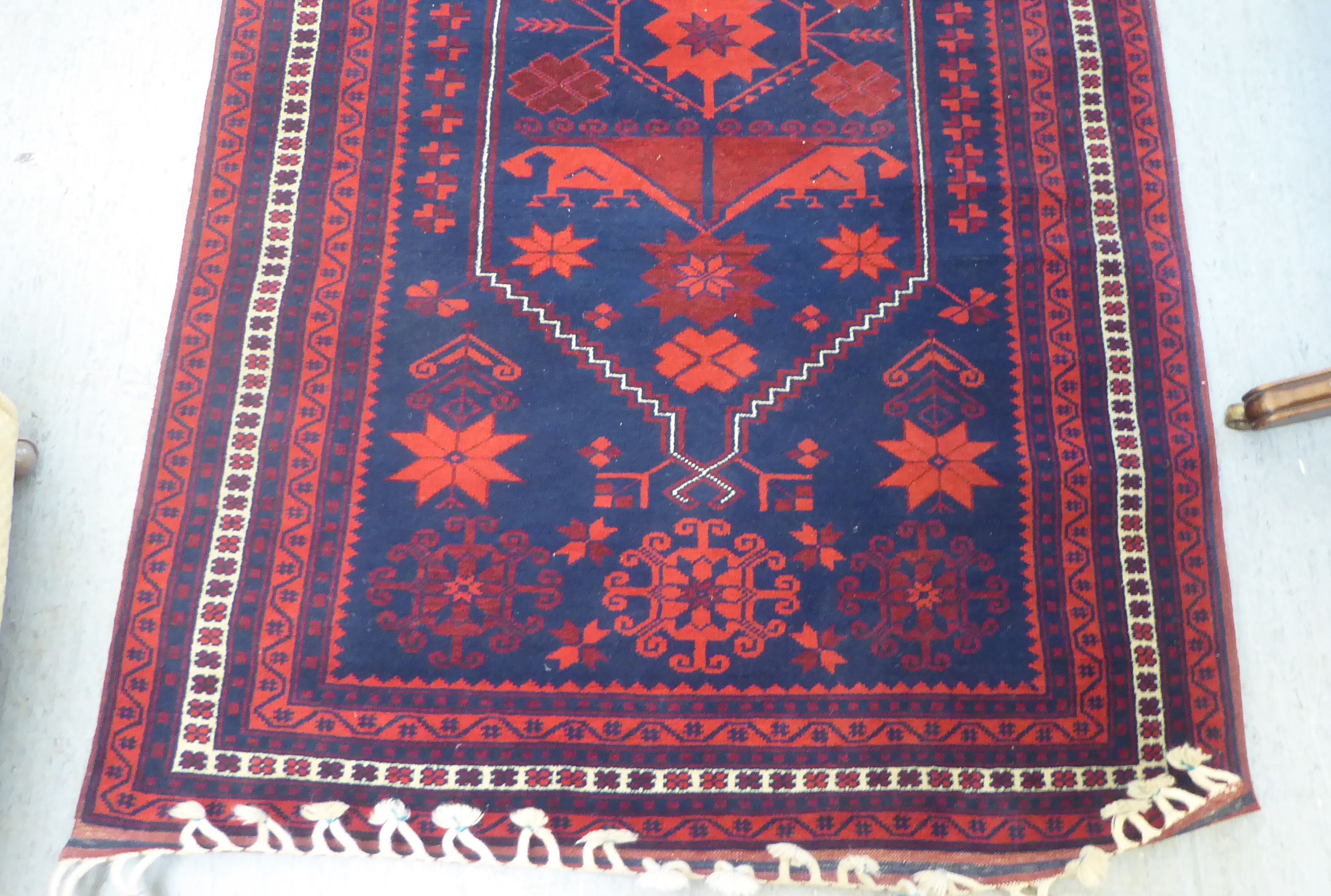 A Turkish rug, decorated with geometric patterns, on a red and blue ground  48" x 78" - Image 2 of 4