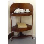 A George III mahogany two tier quadrant washstand, raised on splayed legs  40"h  23"dia