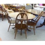 An Ercol mid brown elm dining table, raised on a pedestal base and splayed legs  30"h  47"L; and a