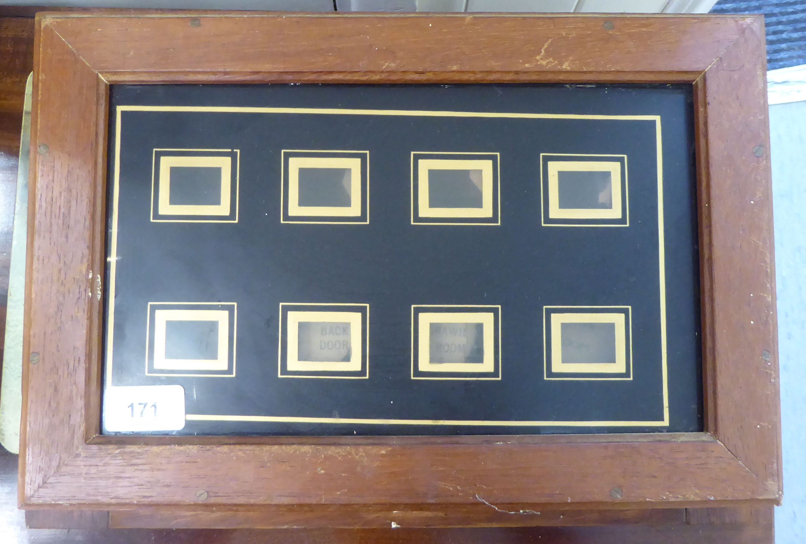 An early 20thC housemaid's bell, in a stained wooden frame  16" x 11"