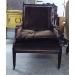 An early Victorian rosewood framed enclosed arm salon chair, decorated in brown fabric, raised on