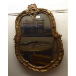 A late 19thC mirror with a shaped plate, in a gilt gesso frame  30" x 22"