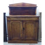 A late Victorian mahogany chiffonier with a raised panelled back, over a frieze drawer and two