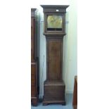 A late 18thC oak longcase clock; the 30 hour movement faced by a brass Roman and Arabic dial,