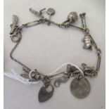 A silver charm bracelet with attendant charms