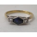 An 18ct bi-coloured gold ring, set with a central sapphire, flanked by two diamonds