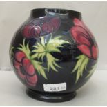 A Moorcroft pottery vase of waisted, baluster form, decorated in relief with flora  bears