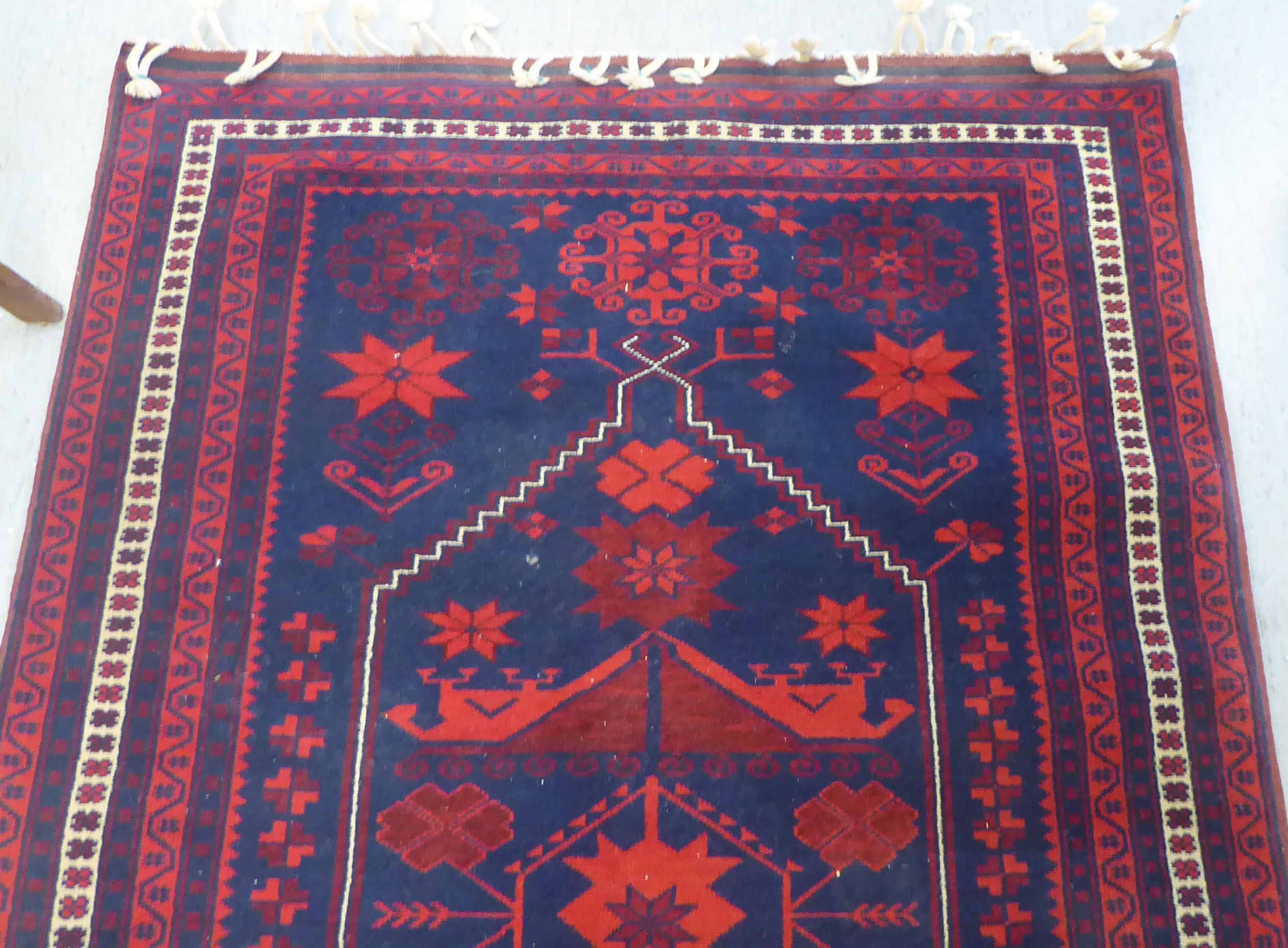 A Turkish rug, decorated with geometric patterns, on a red and blue ground  48" x 78" - Image 3 of 4