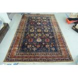 A Persian design rug, decorated with repeating stylised designs, on a multi-coloured ground  76" x