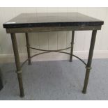 A modern lacquered brass framed occasional table with a mottled black marble top, the reeded legs