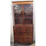 A George III mahogany secretaire bookcase with a glazed upper section, over four graduated