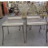 A pair of modern stainless steel framed terrace chairs with crossover arrow splats