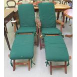 A pair of Teak Tiger Trading folding steamer chairs of slatted design, on rubber wheels with