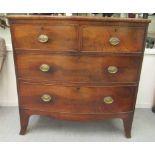 An early 19thC mahogany bow front dressing chest with two short/two long drawers with brass bail