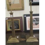 A pair of lacquered brass table lamps, fashioned as tapered, square columns, on plinths  14"h