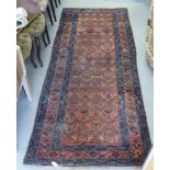 A Persian runner, decorated with repeating stylised designs, on a multi-coloured ground  41" x 106"