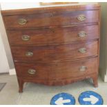 An early 19thC mahogany bow front dressing chest, having an inlaid frieze, over four graduated