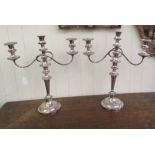 A pair of Georgian style silver plated, two-part candelabra, each with a central socket and two