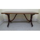 A modern Regency style mahogany coffee table, the crossbanded top with a reeded edge, over a pair of