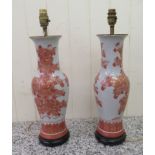 A pair of modern china design table lamps of waisted baluster form, decorated in iron red and