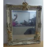 A modern mirror, the plate set in a shabby chic finished frame with composition pixie ornament