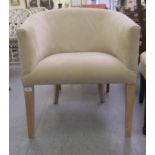 A modern round back chair, stud upholstered in faux cream coloured suede, raised on a square,