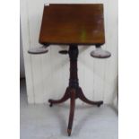 A late Victorian mahogany pedestal lectern/table, raised on splayed legs and casters  31"h