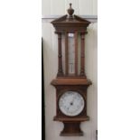 An Edwardian carved light oak framed aneroid barometer  36"h
